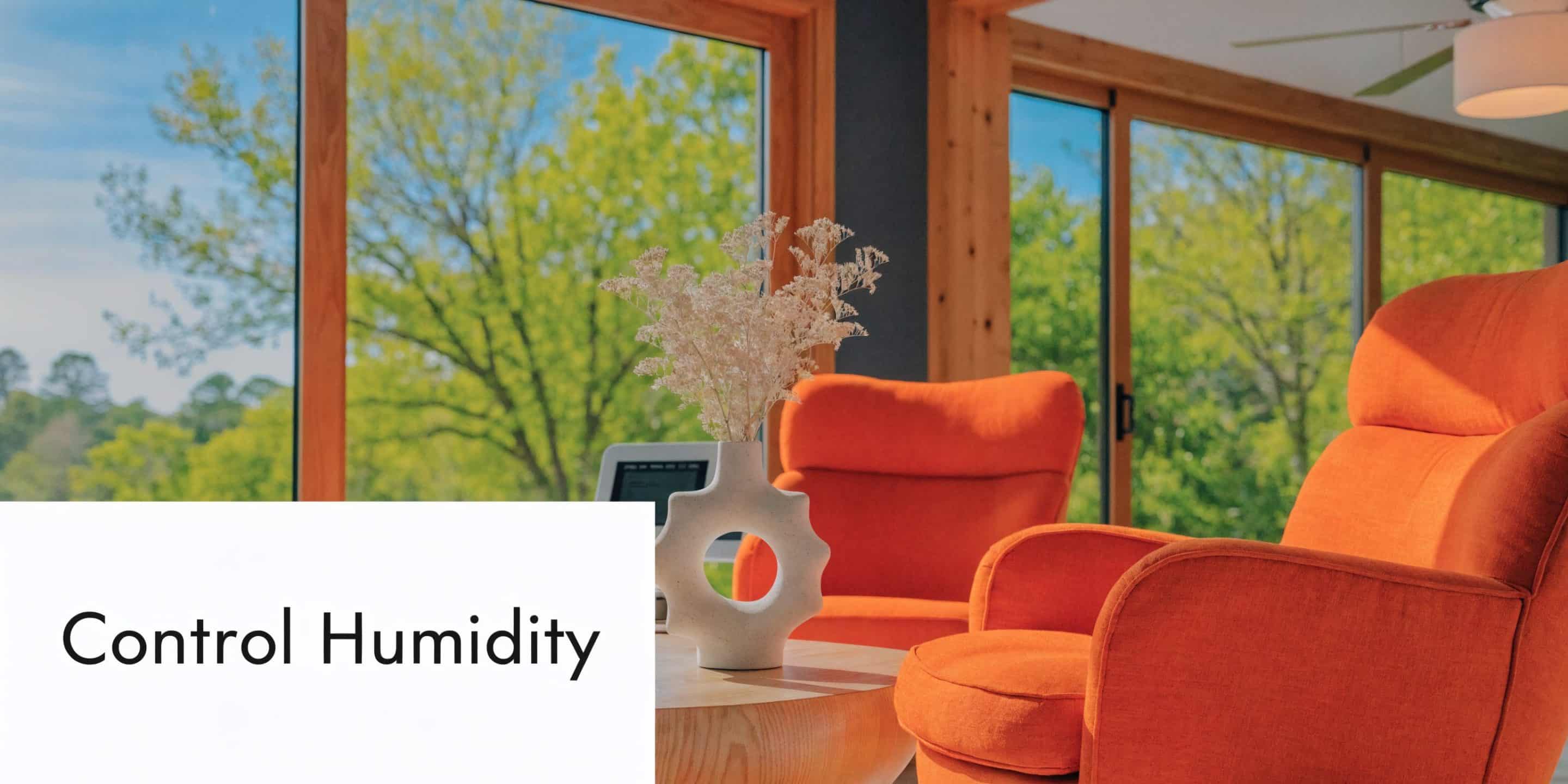 A modern living room with orange armchairs, a wooden coffee table, and a vase with flowers.