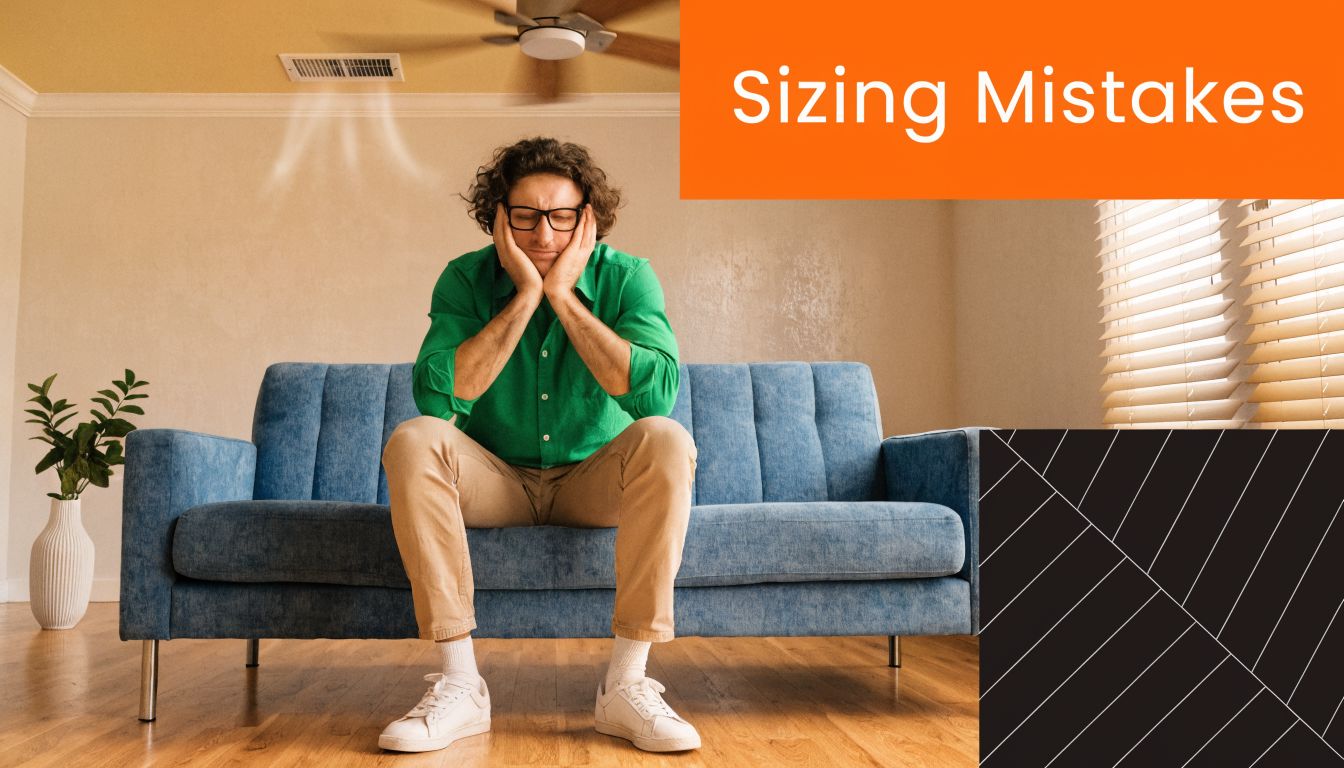 A frustrated man sits on a sofa, representing the common problem of choosing an incorrect air conditioner size.